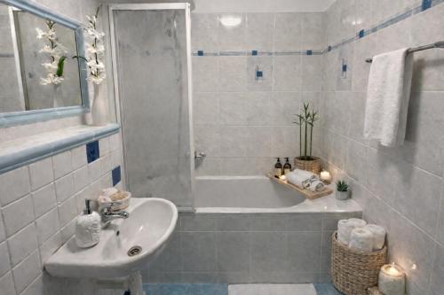 a bathroom with a sink and a shower and a tub at Rezidence - HAMR in Nové Hrady