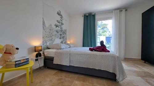 a bedroom with a bed and a window at Azot Villa in Le Tampon