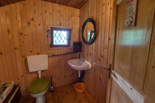 a wooden bathroom with a toilet and a sink at Princess Vogar in Bohinj