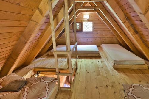 a attic room with two beds and a ladder at Princess Vogar in Bohinj