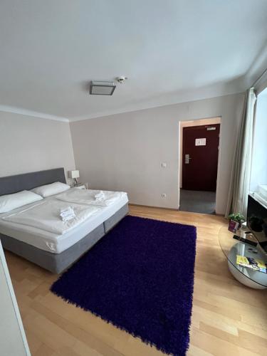 a bedroom with a bed and a blue rug at Urban City Nest in Vienna