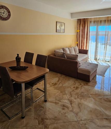 a living room with a couch and a table at Apartment Sea Space 2 in Dobra Voda