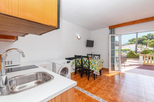 a kitchen with a sink and a dishwasher at Bon repós B5 in Cala en Bosc