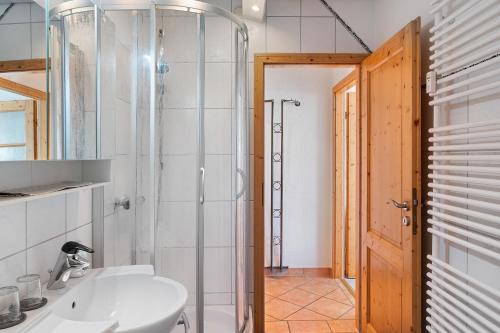 a bathroom with a shower and a white sink at Ferienwohnung Brasil, 76 Qm in Schonach