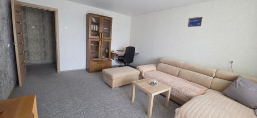 a living room with a couch and a table at Dubysa Apartments in Raseiniai