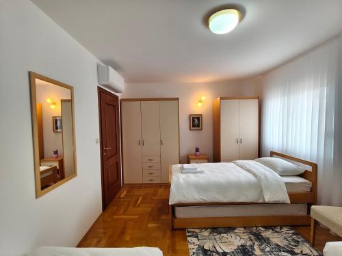 a bedroom with a large bed and a mirror at 2Hearts Apartment - Medjugorje in Međugorje