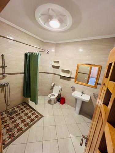 a bathroom with a toilet and a sink at Chez Yamaa in Oualidia