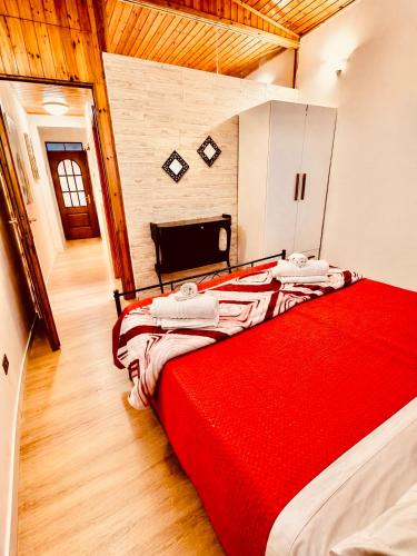 a large bed in a room with a red blanket at Mediterranea Apartment in Agrigento