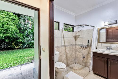 a bathroom with a shower and a toilet and a sink at Hotel Caña Brava Inn in Cañas
