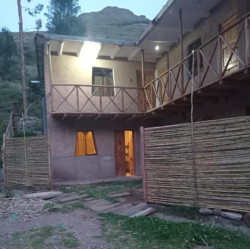 a house with a porch and a balcony at Small House Pisac in Pisac