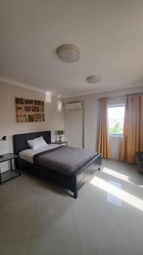 a bedroom with a large bed and a window at Sea View Haven in Accra