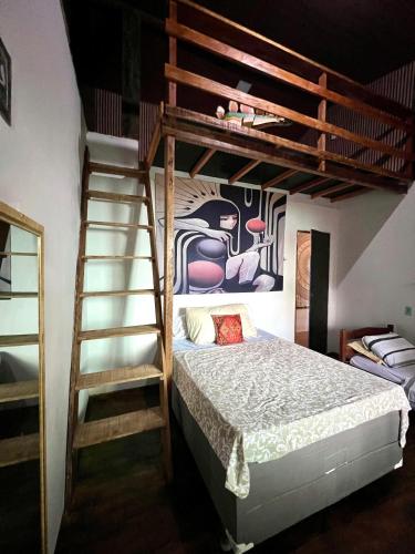 a bedroom with a bunk bed and a ladder at Casa rosa in Maracanã