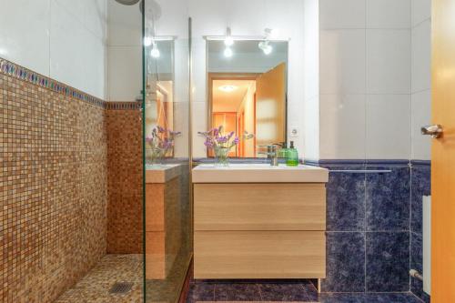 a bathroom with a sink and a shower at Duplex Beach Masnou in El Masnou