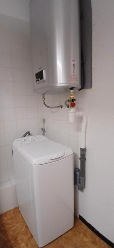 a bathroom with a toilet and a water tank at Yemanja Guest Flat- vue Mer &Salin, piscine, climatisation in Gruissan