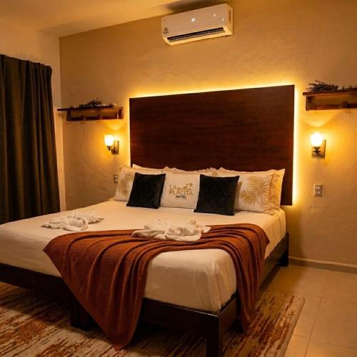 a hotel room with a large bed with towels on it at La placita hotel in Río Lagartos