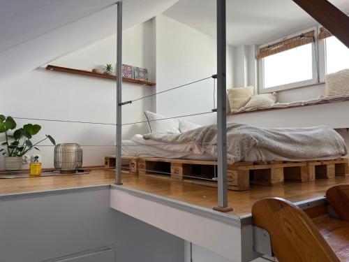 a bedroom with a bed on a wooden bench at Gdynia Bulwar in Gdynia