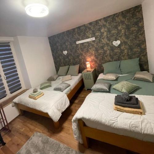 a room with three beds in a room at La Parenthèse in Vitreux
