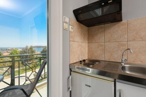 a kitchen with a view of a balcony at Dimitreli Venetia Studios in Koinyra