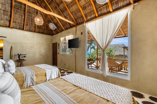 a bedroom with two beds and a window at Panchos Paradise in Puerto Vallarta
