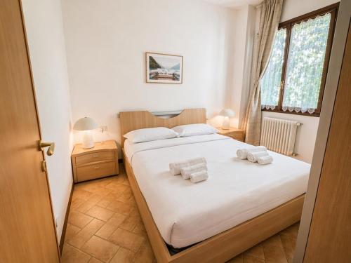 a bedroom with a bed with towels on it at The Terrace Overlooking Lake Como in Muronico