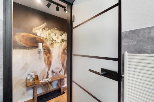 a door with a painting of a cow on it at Forest Elegance in Freudenstadt