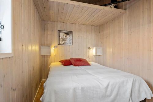 a bedroom with a large white bed with two red pillows at FY417-Assens-Glentevej-8 in Næs