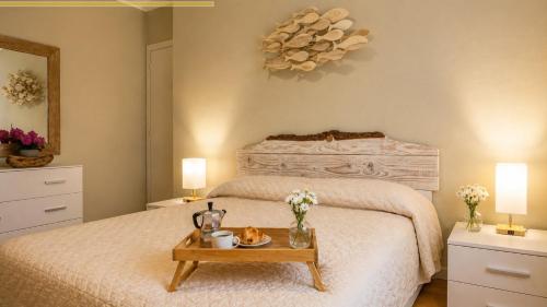 a bedroom with a bed with a tray of food on a table at This is my happy place in Leggiuno