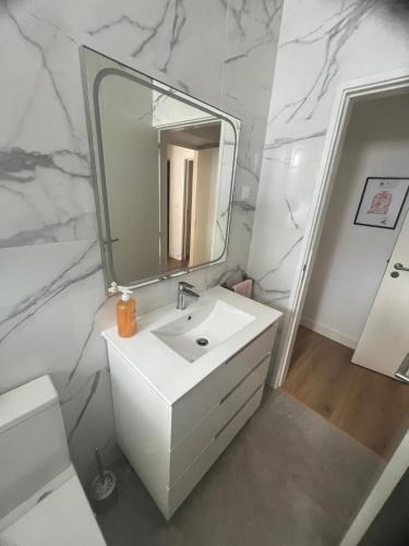 a bathroom with a white sink and a mirror at Refúgio Templário in Pedreira