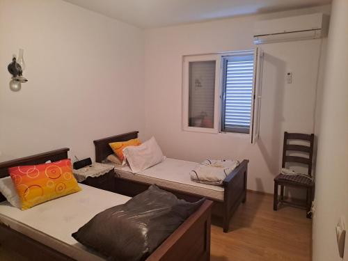a room with two beds and a window at Room 4 U in Bar