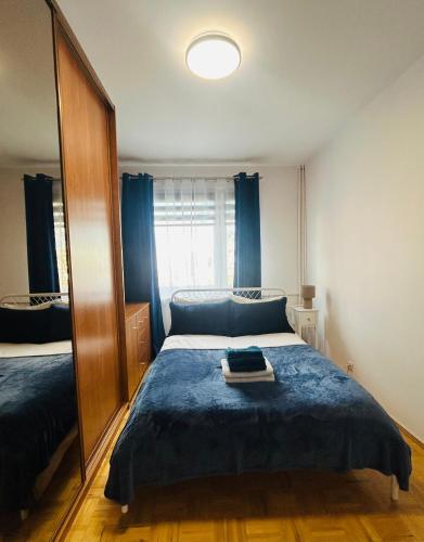 a bedroom with a bed and a large mirror at Włocławek Norwida in Włocławek
