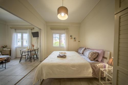 a bedroom with a large bed and a table at Miranta's Studios in Mytilene