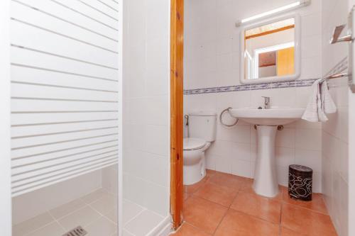 a bathroom with a toilet and a sink at Bon repós B11 in Cala en Bosc