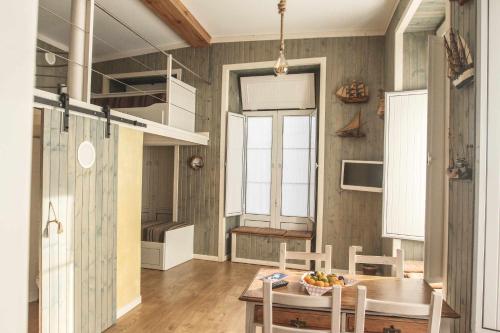 a kitchen and dining room with a table and chairs at THE BOAT - Apartamento Temático in Seixal