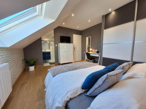 a bedroom with a large bed and a desk at Le Garage & Spa Silver in Gondreville