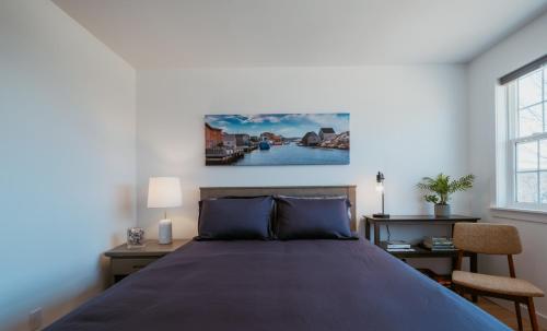 a bedroom with a large bed and a window at Cherry Lane Cottage | 3 Bed & 2 Bath in Foxtrap