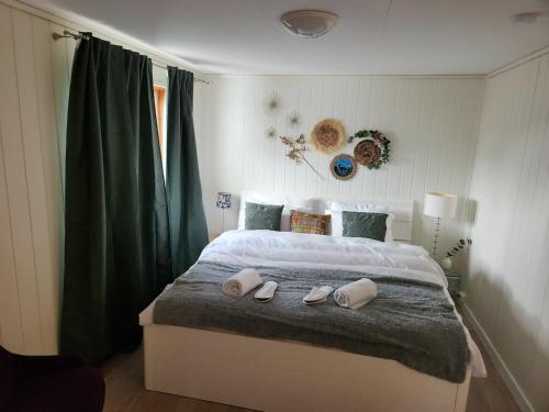 a bedroom with a bed with shoes on it at Gate 1 apartment in Måløy