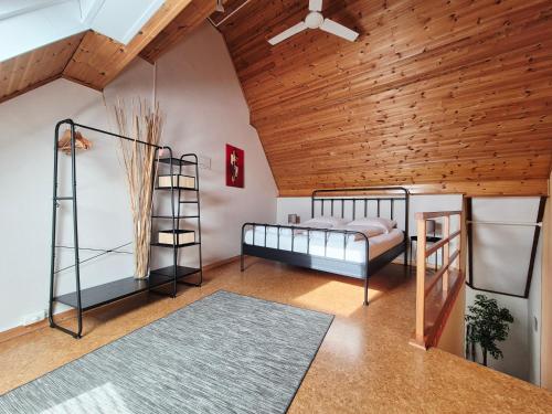 two bunk beds in a room with a wooden ceiling at Sweet&City STUDIO in Saint-Vith