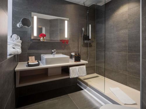 a bathroom with a sink and a shower at Mercure Vienna First in Vienna