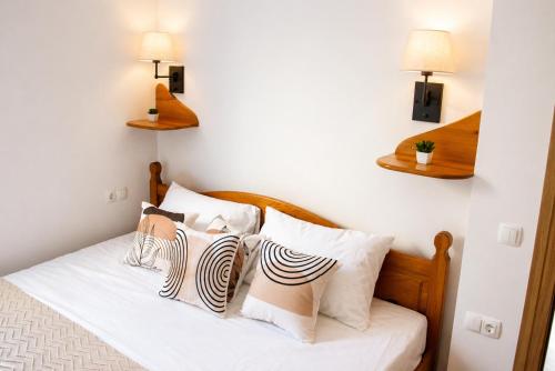 a bedroom with a bed with pillows on it at Little Vine House in Mostar