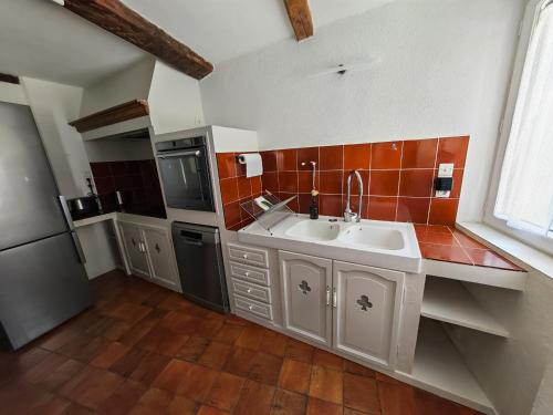 a kitchen with a sink and a counter top at Clair de Provence in Entrevennes
