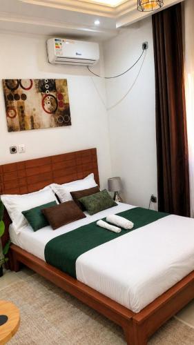 a bedroom with a large bed in a room at Skyline Residence Apartment in Douala in Douala