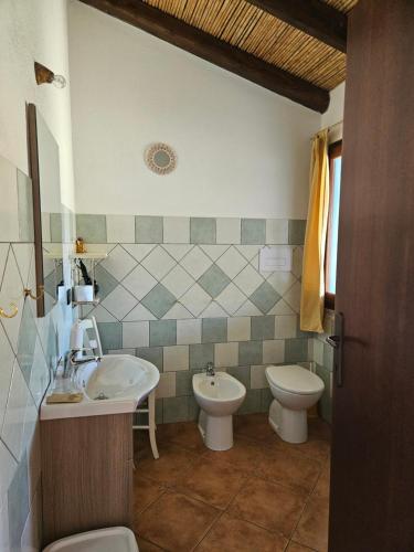 a bathroom with a sink and a toilet at Tenuta Don Ballore Country Resort in Galtellì