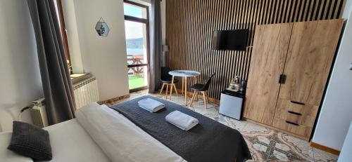 a bedroom with a bed with two pillows on it at O.W. LAZUR nad jeziorem in Żywiec