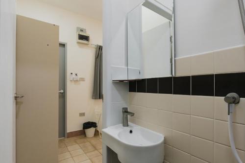 a bathroom with a sink and a mirror at Kavana Kata Residence in Phuket