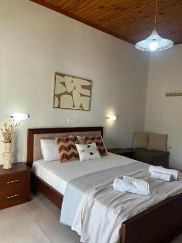 a bedroom with a large bed and a chair at Antonio Studios in Alikanas