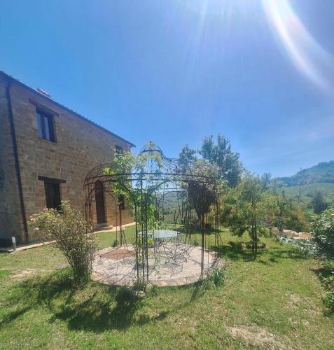 a garden with trees in front of a building at casa Bel Posto in San Ginesio