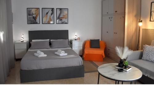 a bedroom with a bed and a couch and a table at Castle View in Samothraki