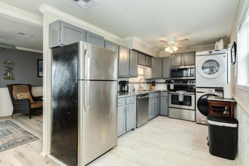 a kitchen with a stainless steel refrigerator and appliances at Beachfront - Private Walkover to Beach in Surfside Beach