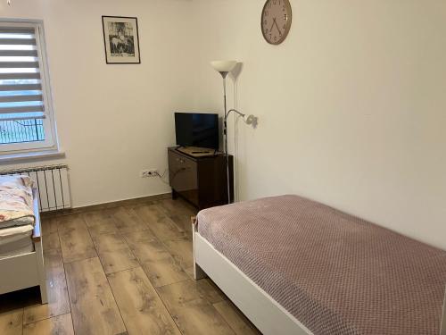 a bedroom with a bed and a tv in it at Don Kichot in Grajewo