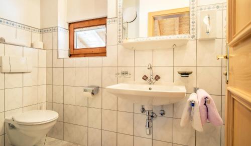 a bathroom with a toilet and a sink at Apart Garni Almfried in Ischgl